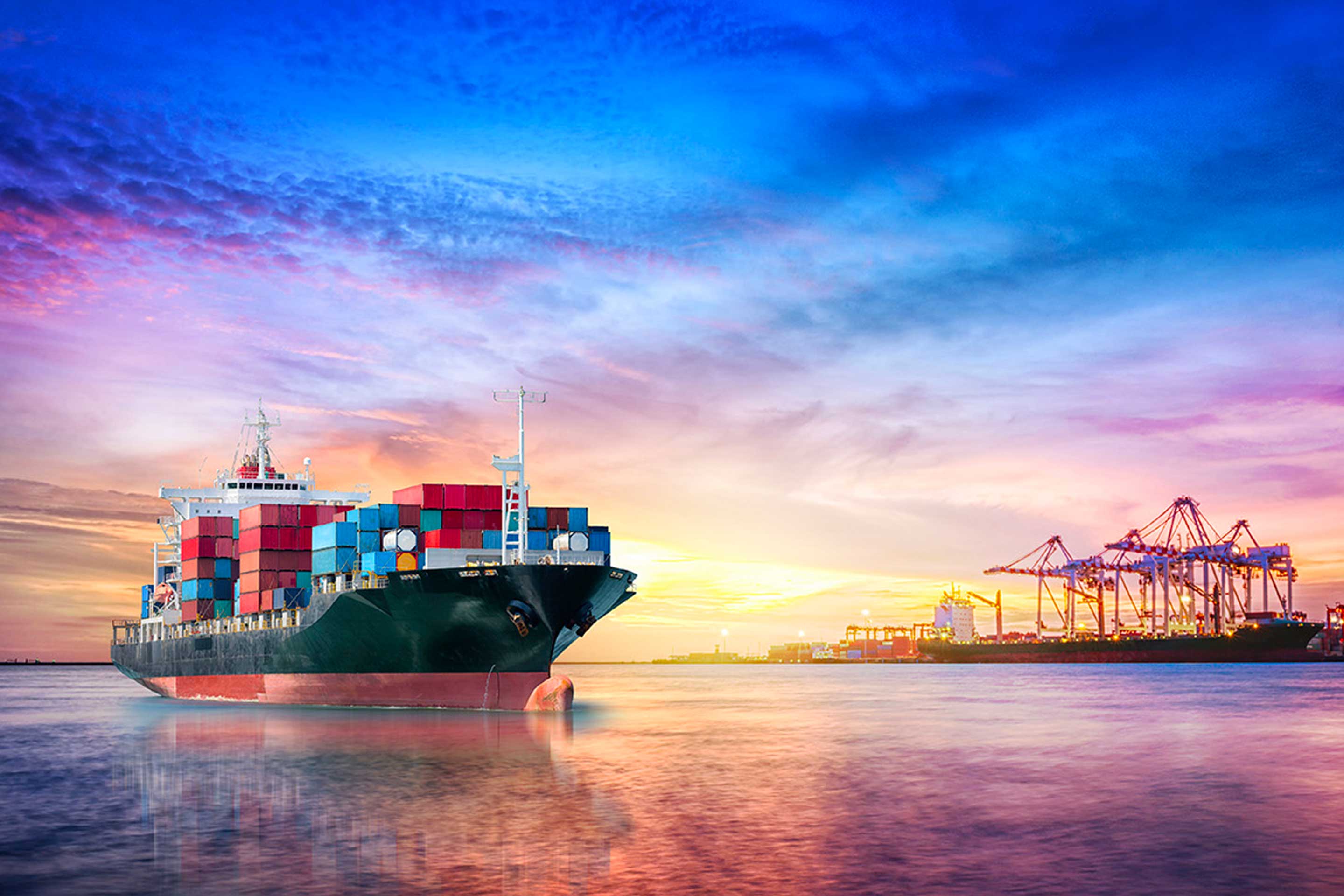 An image of a containership at sunset to highlight Christoph Rofka's interview on decarbonization in the marine industry