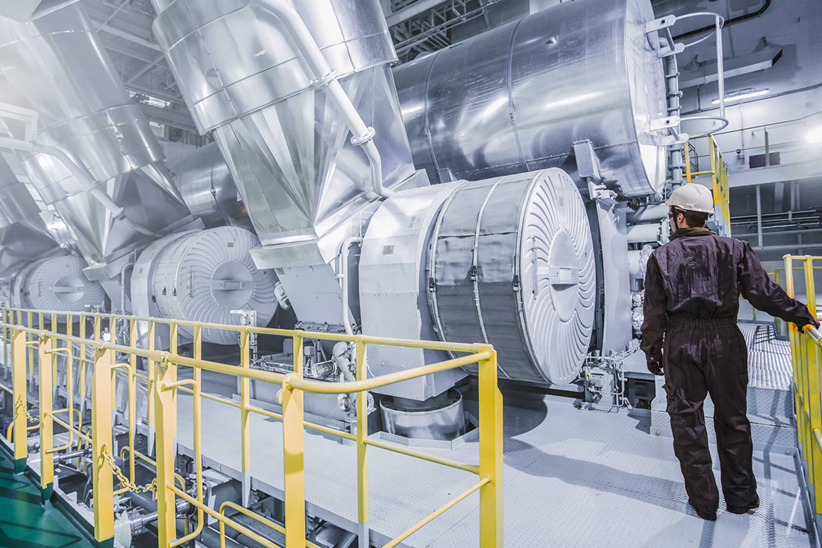 An image of an Accelleron engineer alongside Accelleron turbochargers