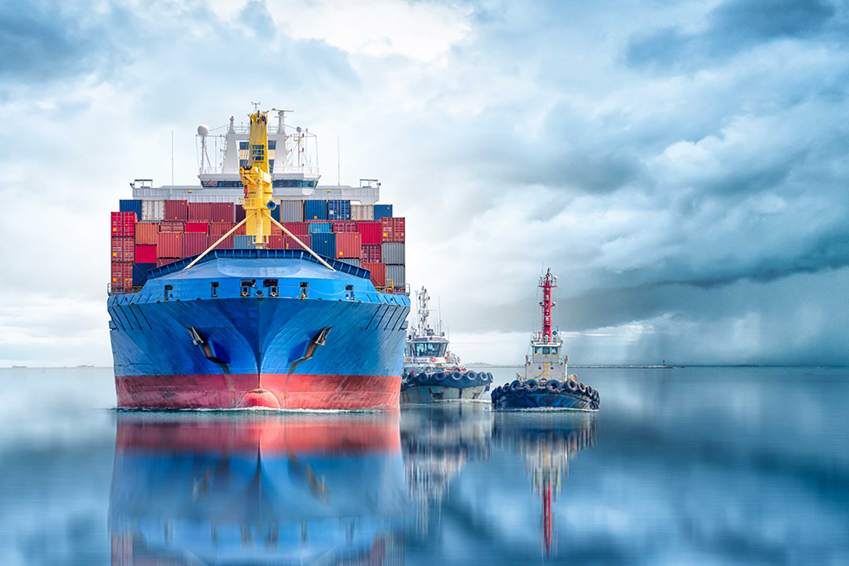 An image of a container ship and tug boats to highlight the Accelleron ship owners survey